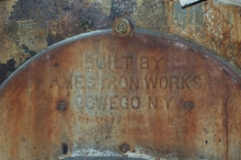 This 1930s era coal boiler, converted to oil, was chopped up and removed to make way for a new domestic hot water heater.  © 2015 IntelliGreen Partners LLC