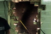 Once we discovered that the base of the chimney was behind a wall, we had to cut open the wall to clean out decades of compressed coal and No. 6 oil soot.