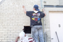 The workmen mark the 5' x 10' space they need to cut into the wall to access the chimney offset and install the remaining chimney liner to the top of the chimney.