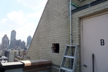 One flight above the Penthouse Level on the roof of this building we marked the 5' x 10' space needed to cut into the wall to access the chimney offset and install the remaining chimney liner to the top of the chimney. © 2013 IntelliGreen Partners, LLC