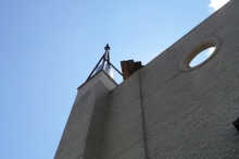 This is the same building showing the chimney liner protruding above the masonry chimney, as required by code. The hoisting gear has not yet been removed.