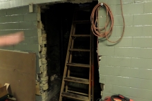 LL43 Site Visit. Controlled Combustion opened up the chimney from the basement hallway to remove the accumulated coal soot and fly ash.