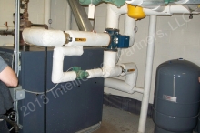LL87/09 energy auditor and retro-commissioning agent note that these properly insulated hot water piping in the boiler room saves energy costs by reducing heat loss.  © 2015 IntelliGreen Partners LLC